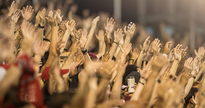 a group of people raising their hands