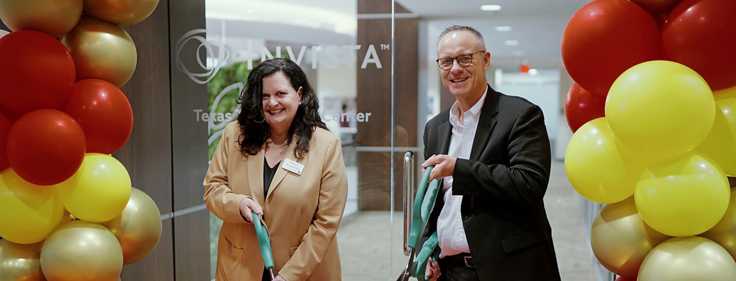 a man and woman cutting a ribbon