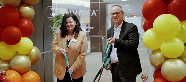 a man and woman cutting a ribbon