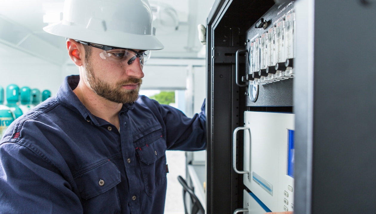 a man wearing a hard hat and glasses