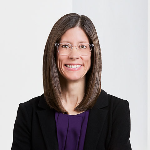 a woman wearing glasses and a black jacket