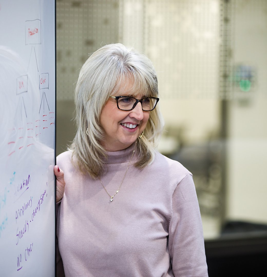 Woman writing at a whiteboard