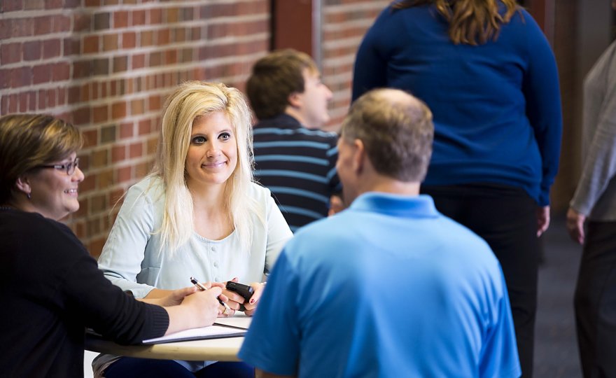 Employees collaborating at a table.