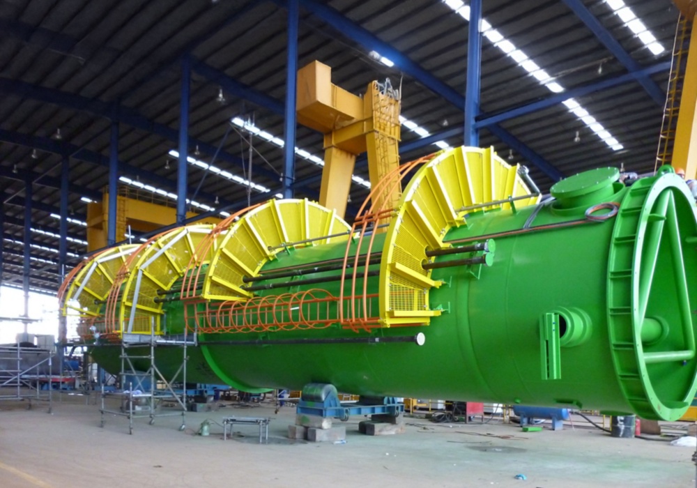 a large green and yellow machine in a factory