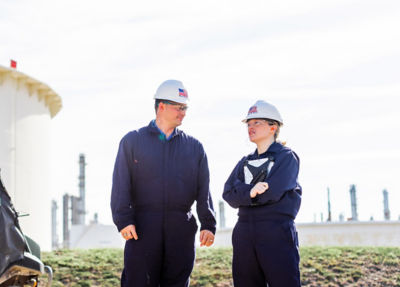 a man and woman wearing hard hats