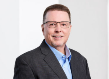 a man wearing a suit and glasses