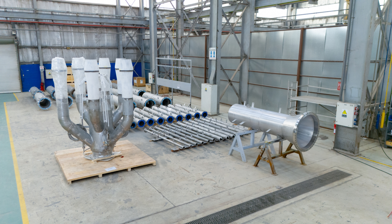 a large room with metal pipes