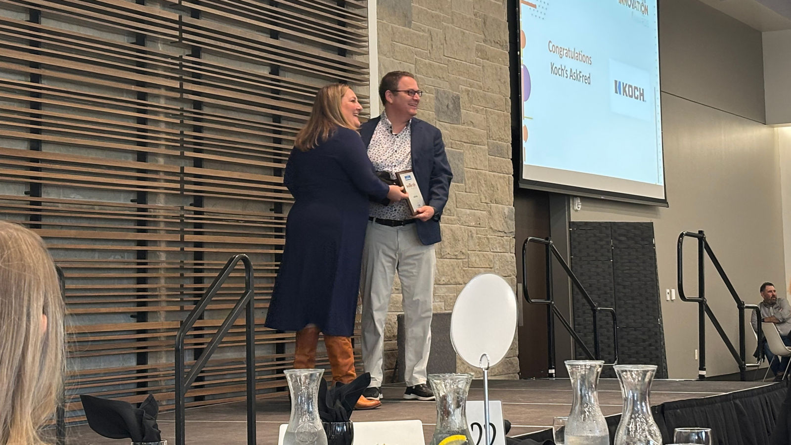 a man and woman standing on a stage