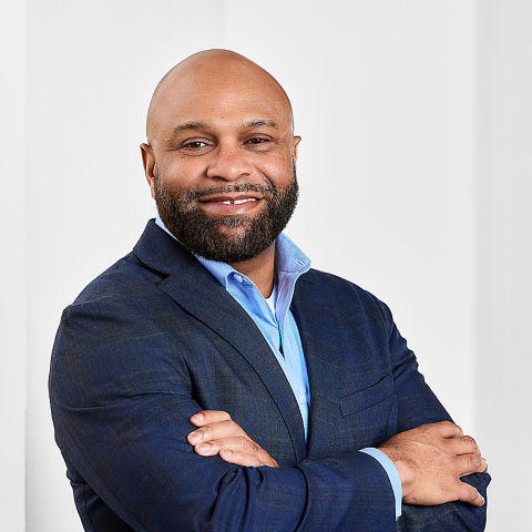 a man in a suit with his arms crossed