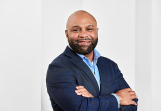 a man in a suit with his arms crossed