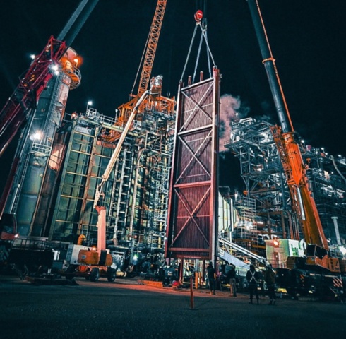 a large crane lifting a door