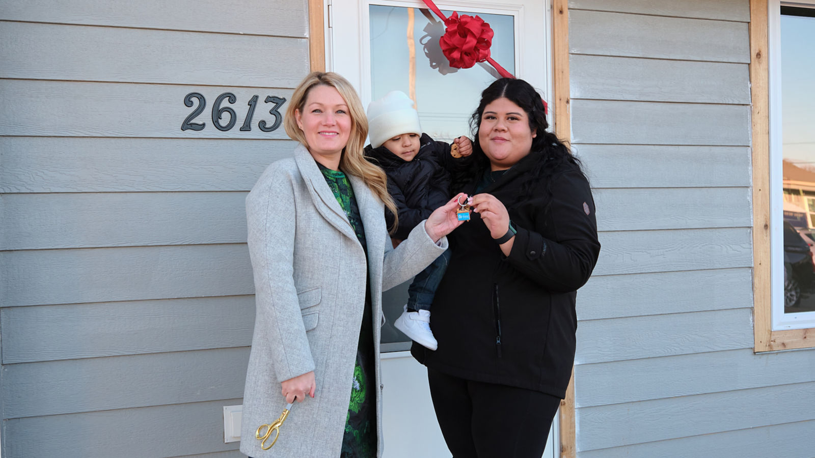a group of women standing outside a house