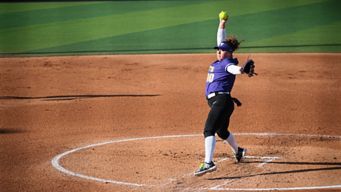 a woman throwing a ball