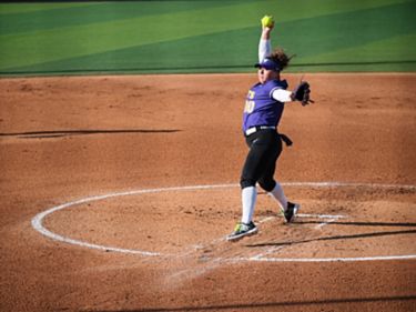 a woman throwing a ball