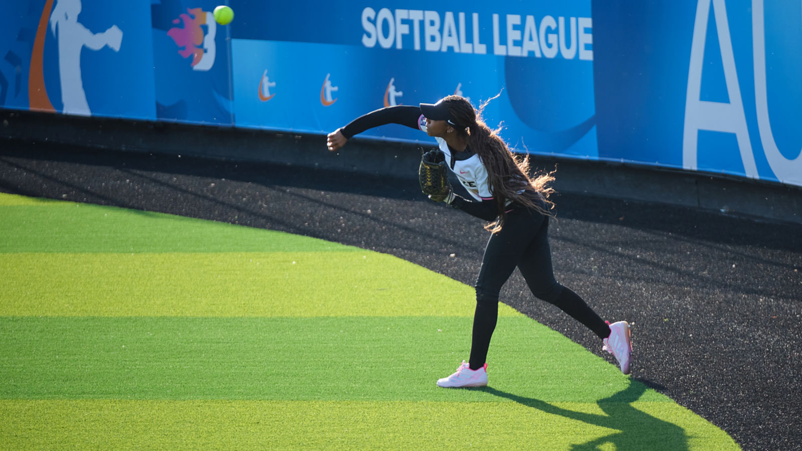 a woman throwing a ball
