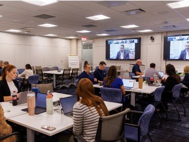 a group of people sitting at tables in a room