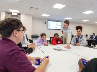 a group of people sitting around a table