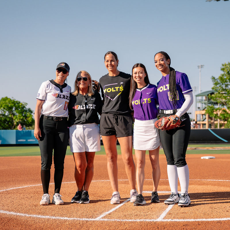 a group of women standing on a field