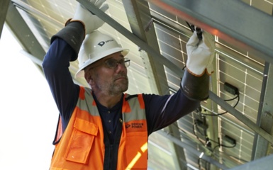a man in a reflective vest and white helmet