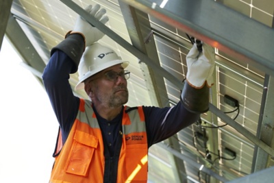 a man in a reflective vest and white helmet