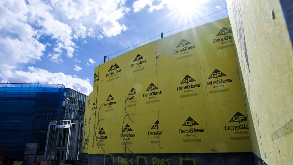 a large yellow wall with black logos