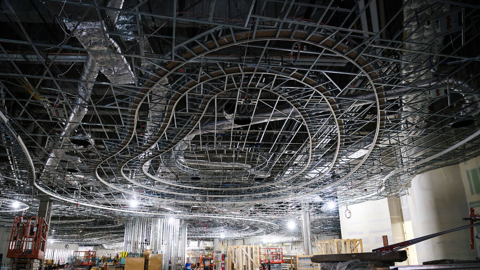 a large warehouse with pipes and scaffolding