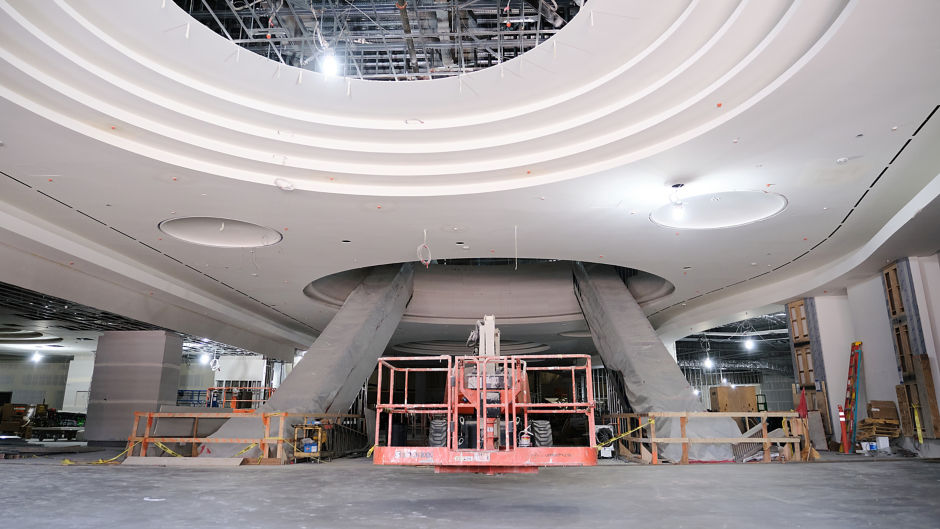 a large white ceiling with a red scaffolding