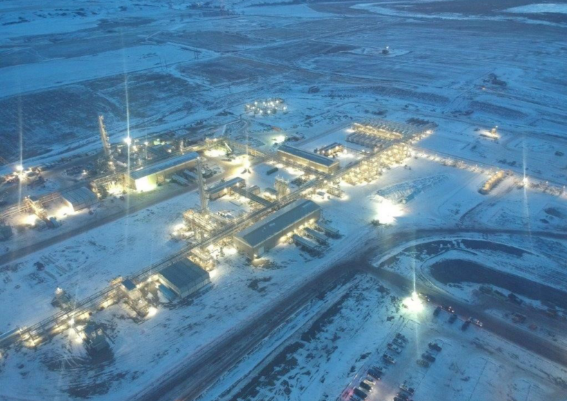 an aerial view of a factory in the snow