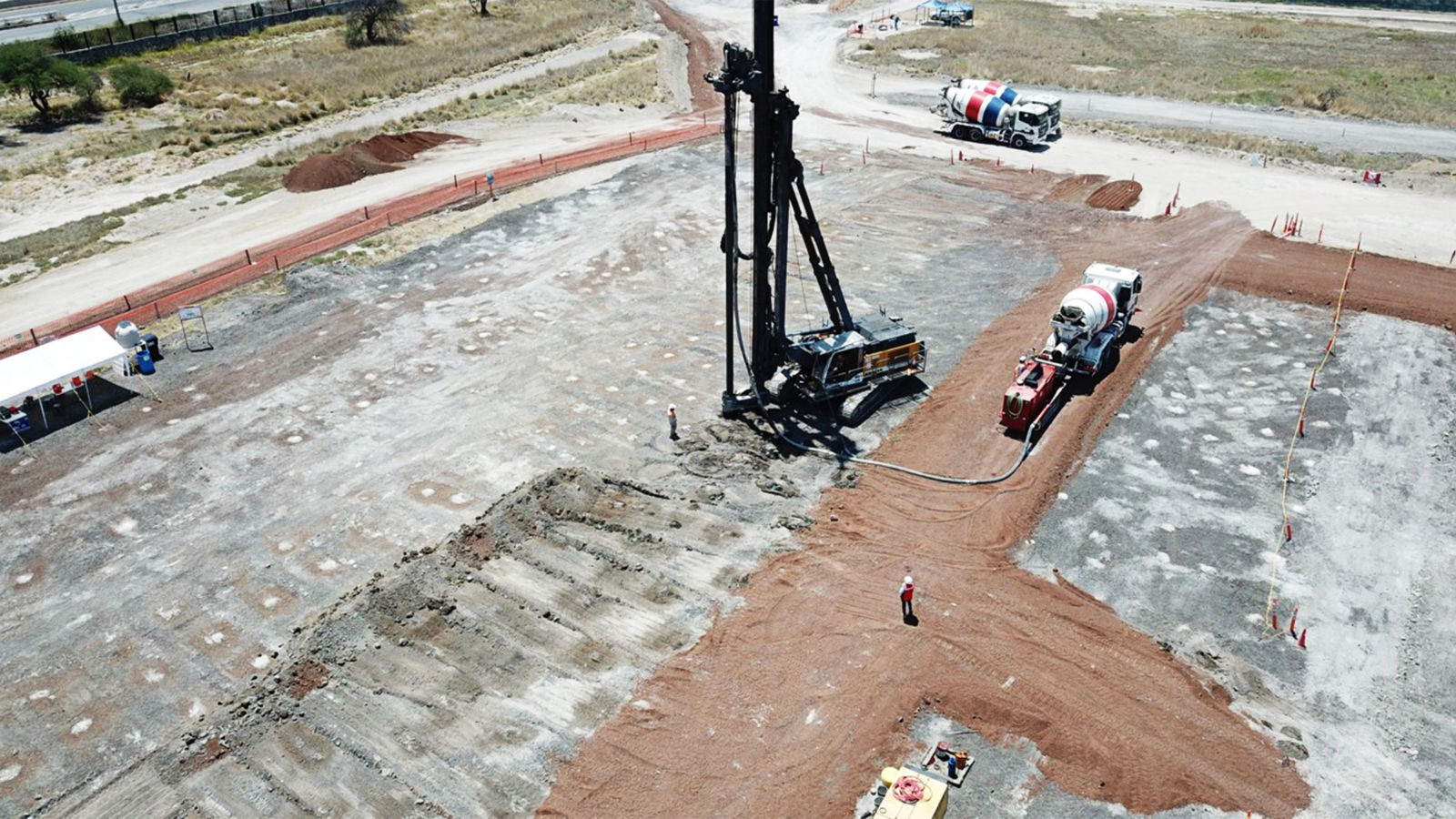 a construction site with a crane and trucks