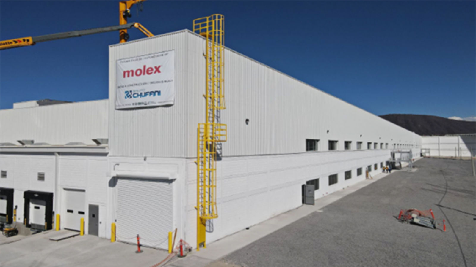 a large white building with yellow ladders