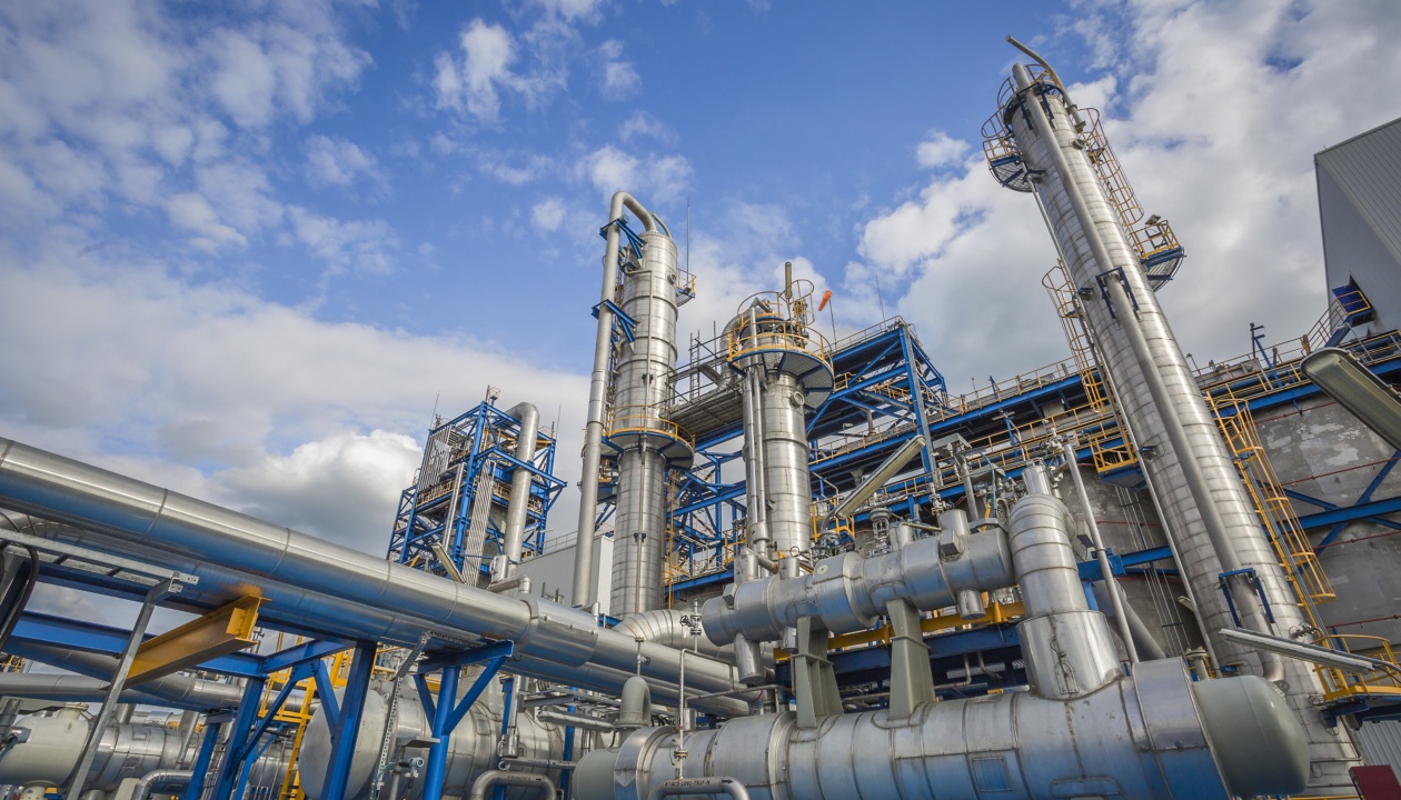 a large industrial plant with blue and yellow pipes