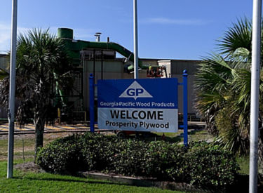 a sign in front of a factory