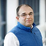 a man wearing a blue vest