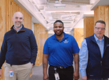 a group of men standing in a hallway