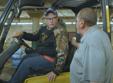 a man sitting on a forklift