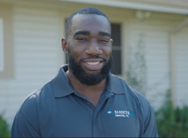 a man with a beard smiling