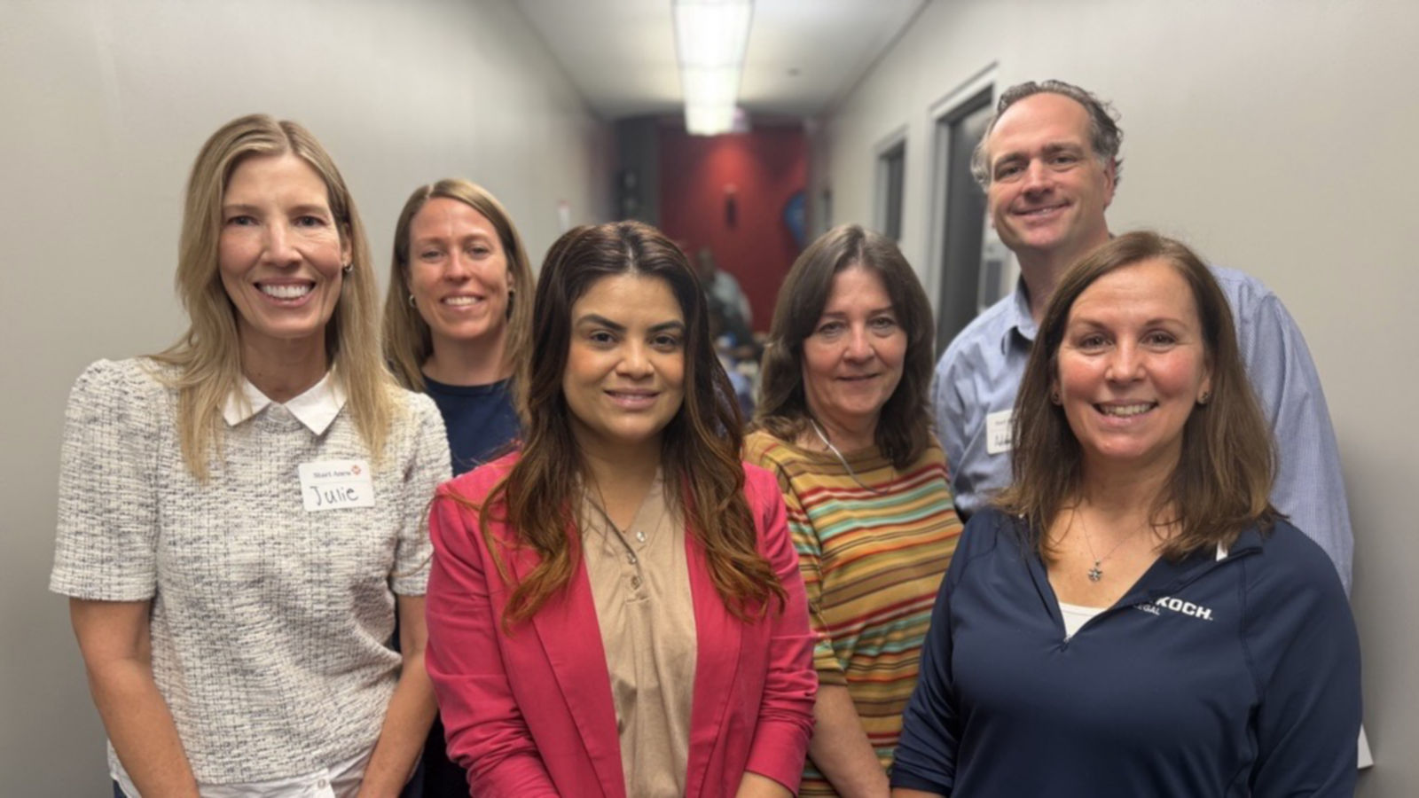 a group of people standing in a hallway