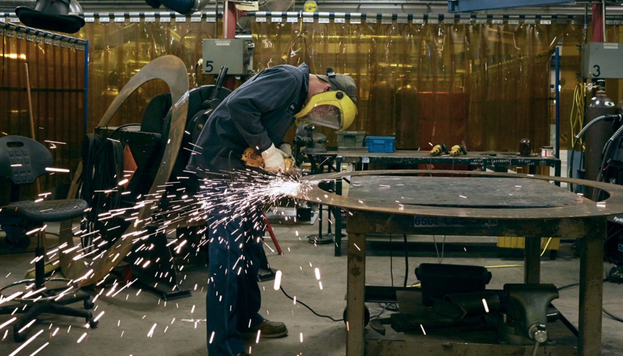 a man grinding a piece of metal