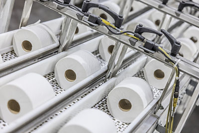 rolls of toilet paper on a conveyor belt