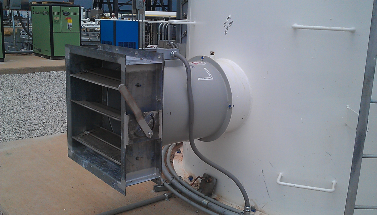 a large white cylinder with a metal door