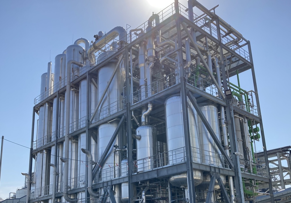 a large industrial plant with many silver tanks