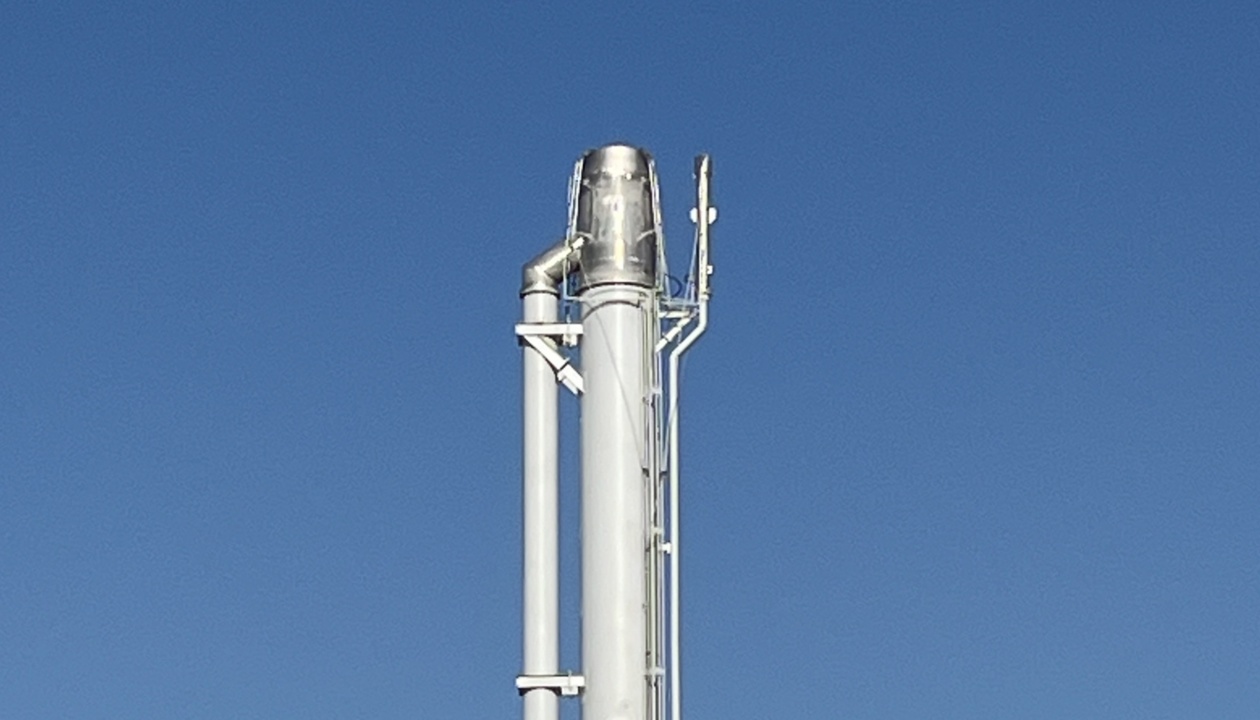 a white pipe with a blue sky