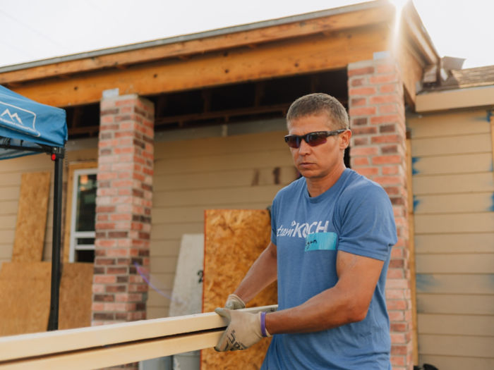 a man carrying a beam