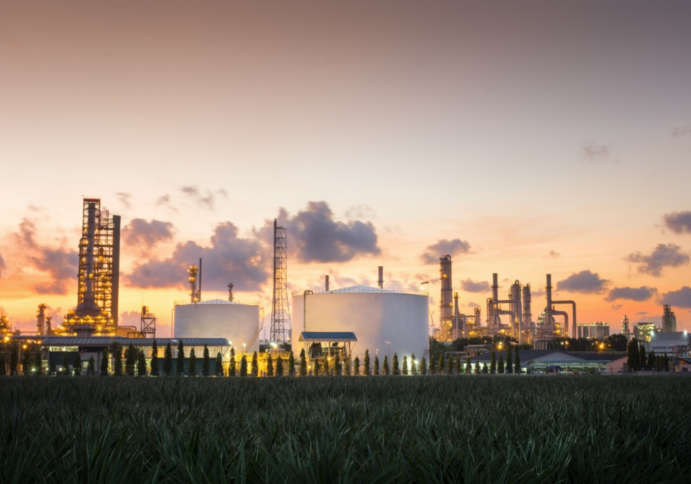 a large factory with a field of grass