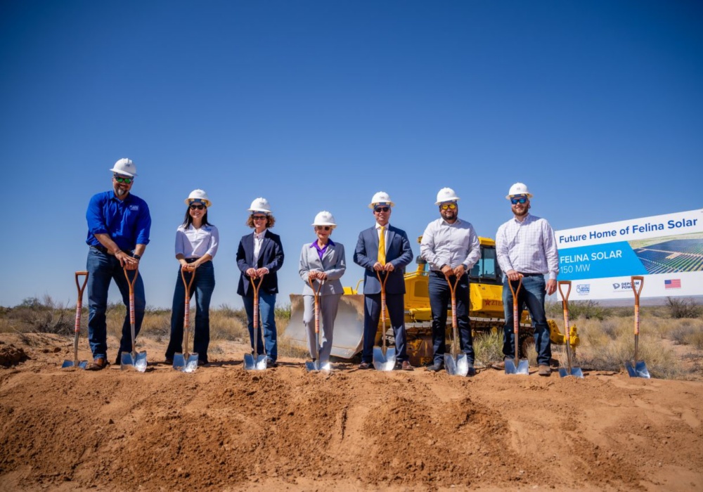 a group of people wearing hard hats and holding shovels
