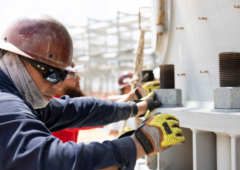 a man wearing a hard hat and gloves