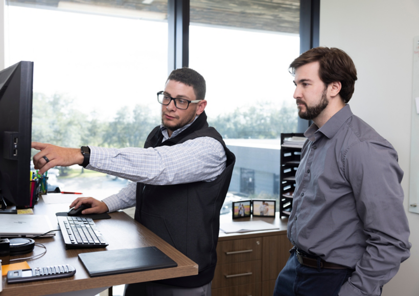 a man pointing at a computer screen