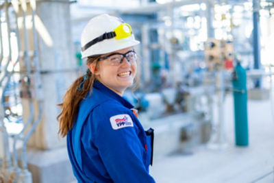 a woman wearing a hard hat and blue shirt