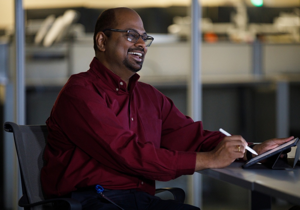 a man sitting at a desk using a pen