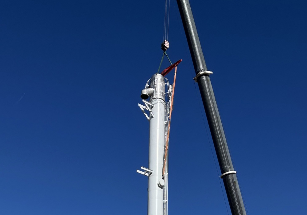 a crane lifting a pole